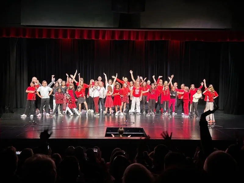 A full cast of students on stage during the end of term showcase